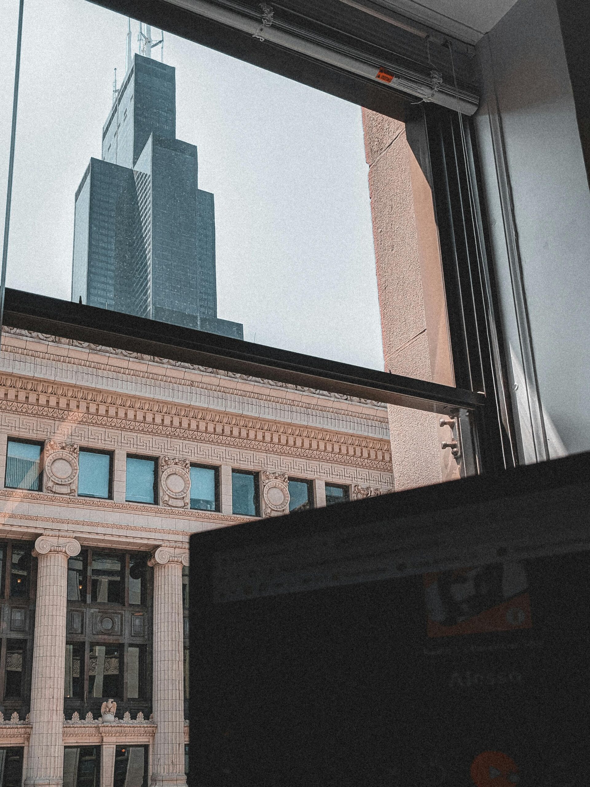 Skyscraper and Building behind Window